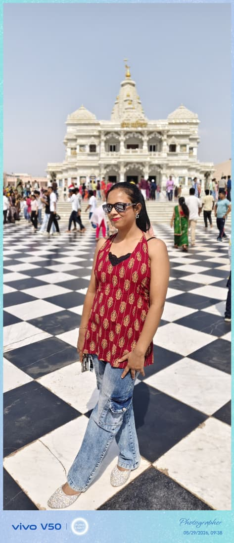 A visitor in the marble courtyard of a white temple complex