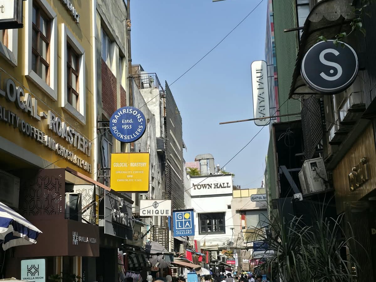 A lively Delhi market lane lined with shops and cafés