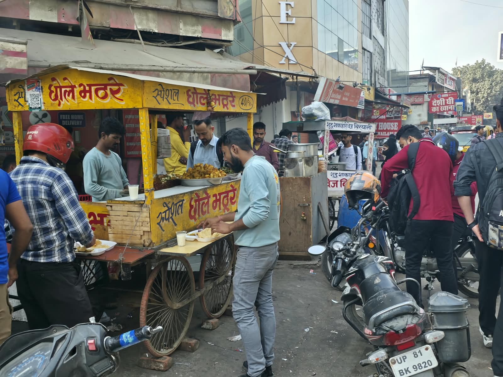 A street food cart serving chole bhature on a busy Indian street